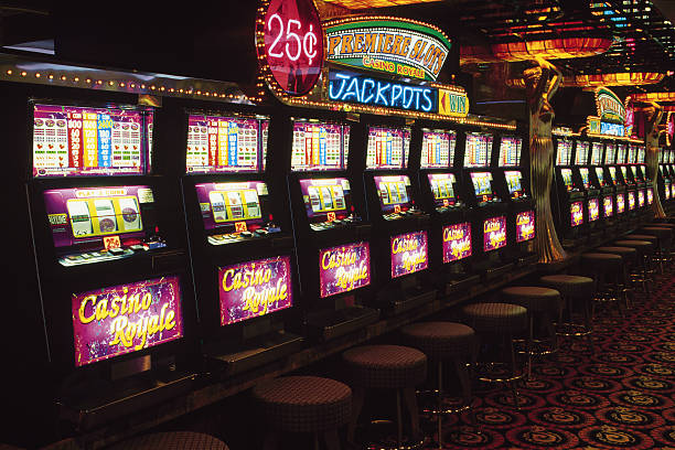 Mobile phone showing Fortune Tiger slot with stake controls, balance display, and spin button on redeem app